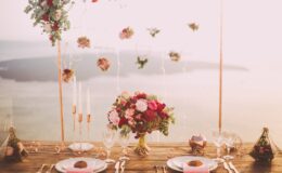 pink and red roses centerpiece near silverwares