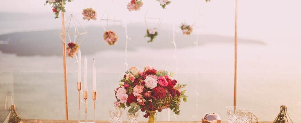 pink and red roses centerpiece near silverwares