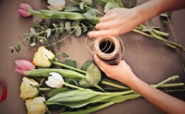 person s hand near flowers