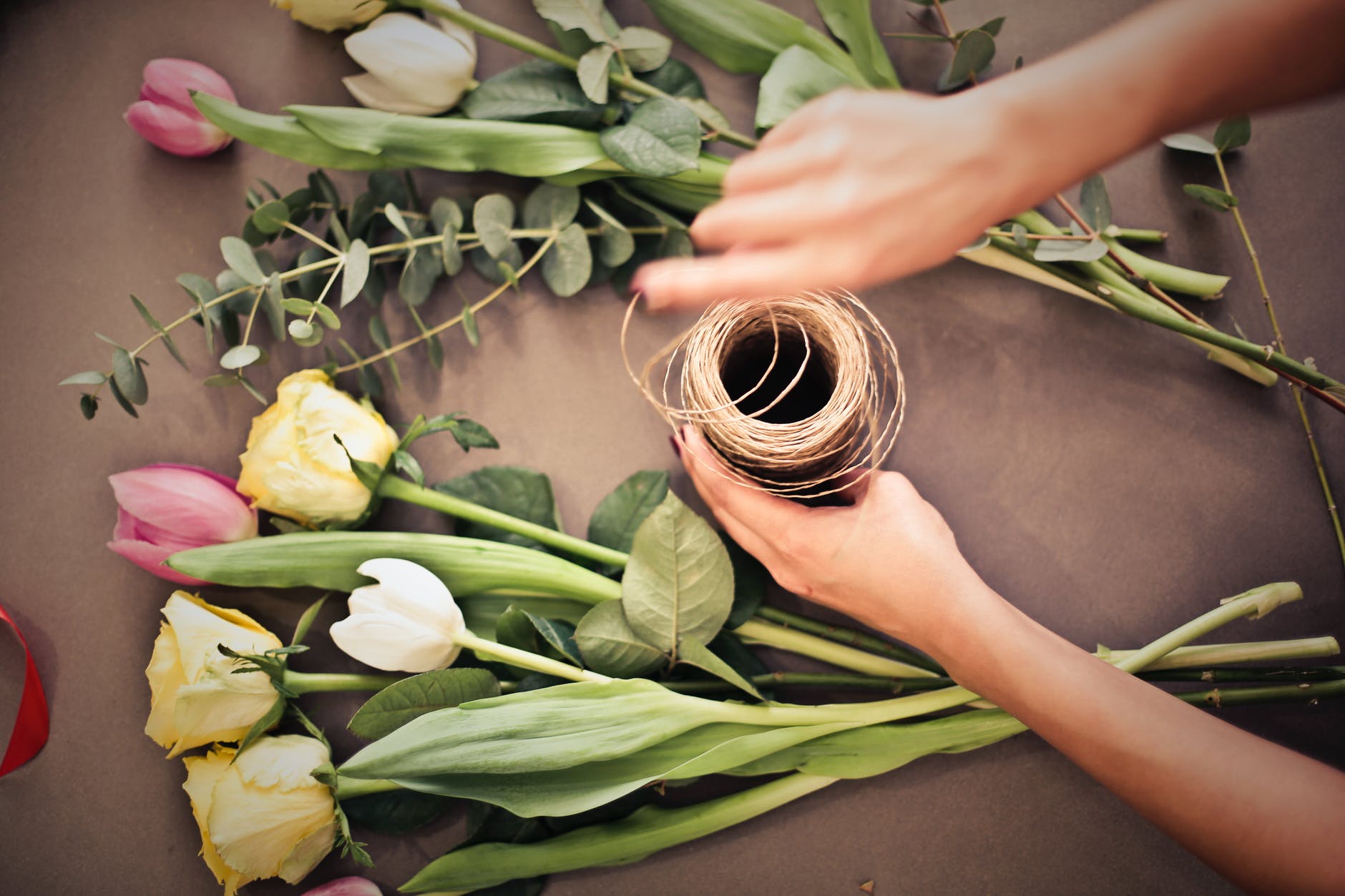 person s hand near flowers