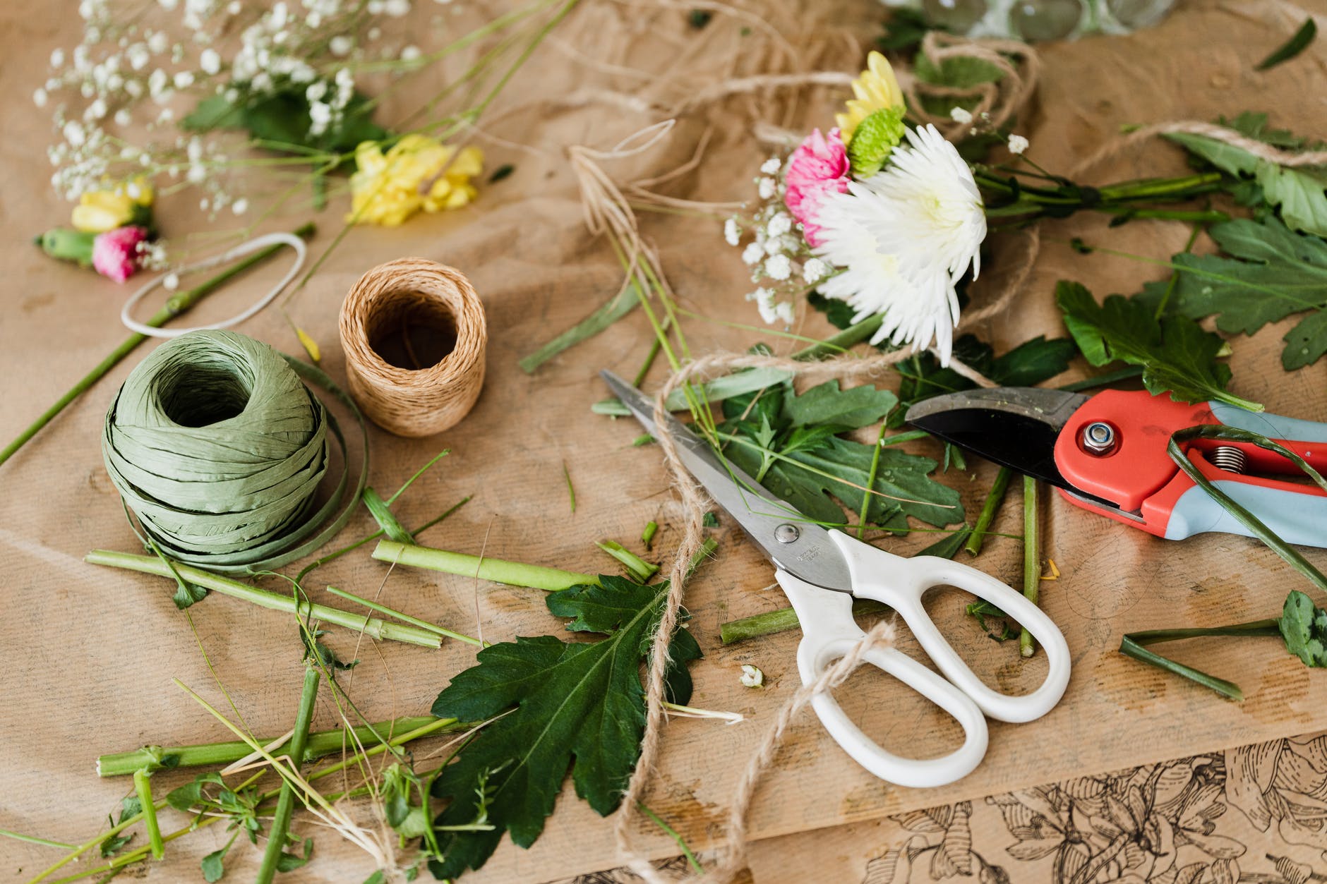 pruners and scissors together with twine in florist shop