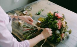 person arranging a bouquet of flowers