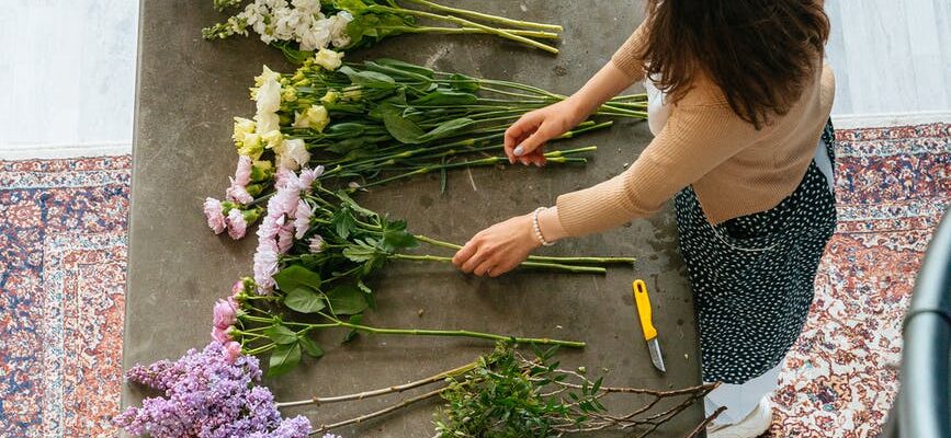 top view of a woman making flower arrangement