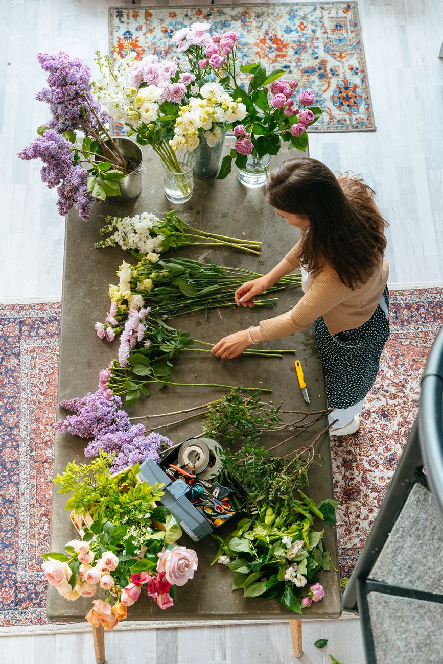 top view of a woman making flower arrangement