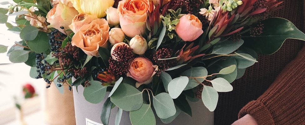 orange tulips in gray plant pot