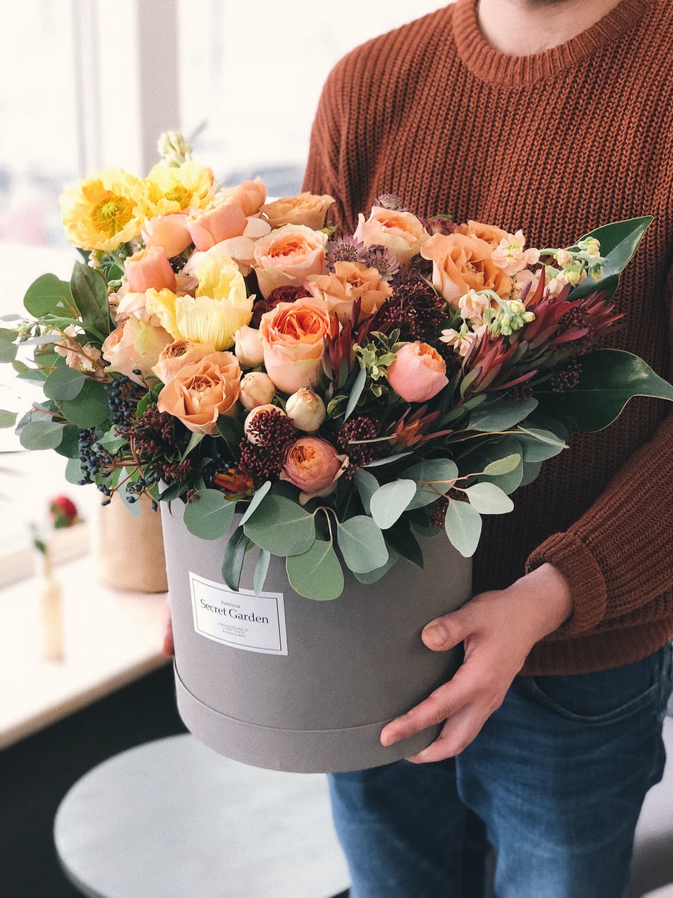 orange tulips in gray plant pot